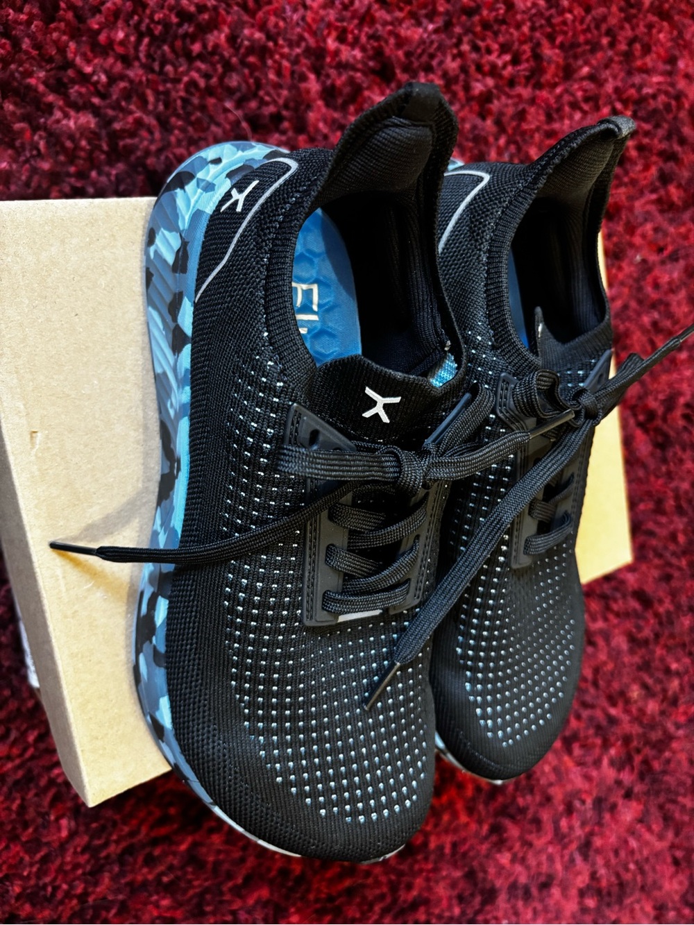 Men's and women’s Black Athletic Sneakers with Blue Camouflage Sole.